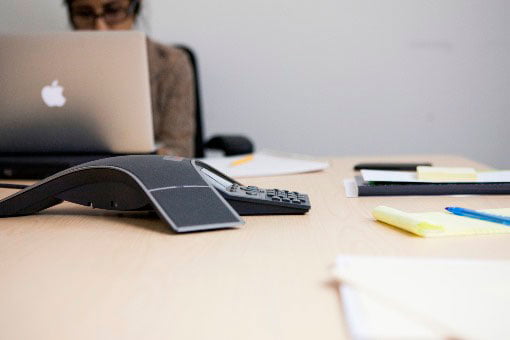 Woman sitting at desk, computer in front of her